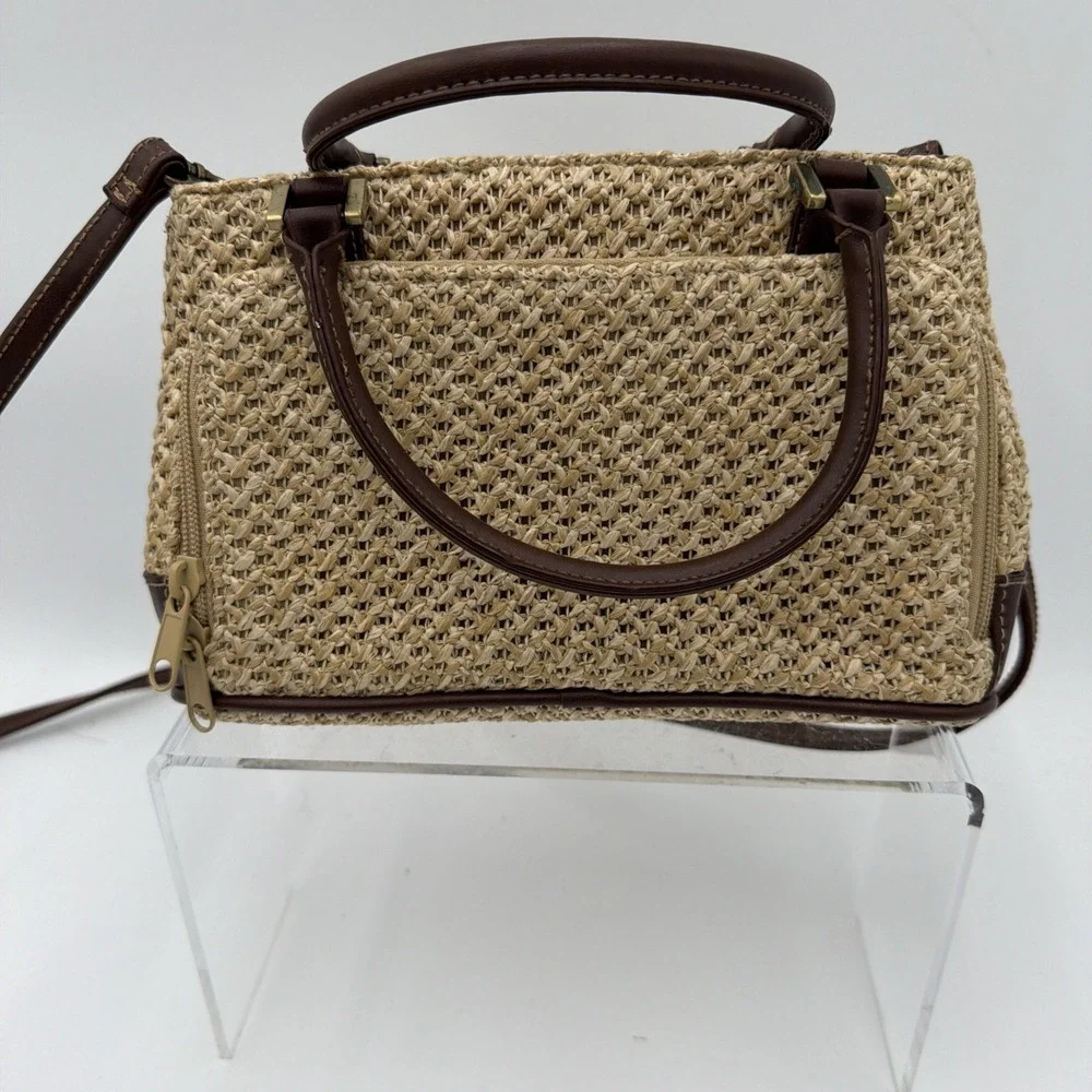 Rosetti straw tote handbag with brown faux leather trim‎ and top handles.